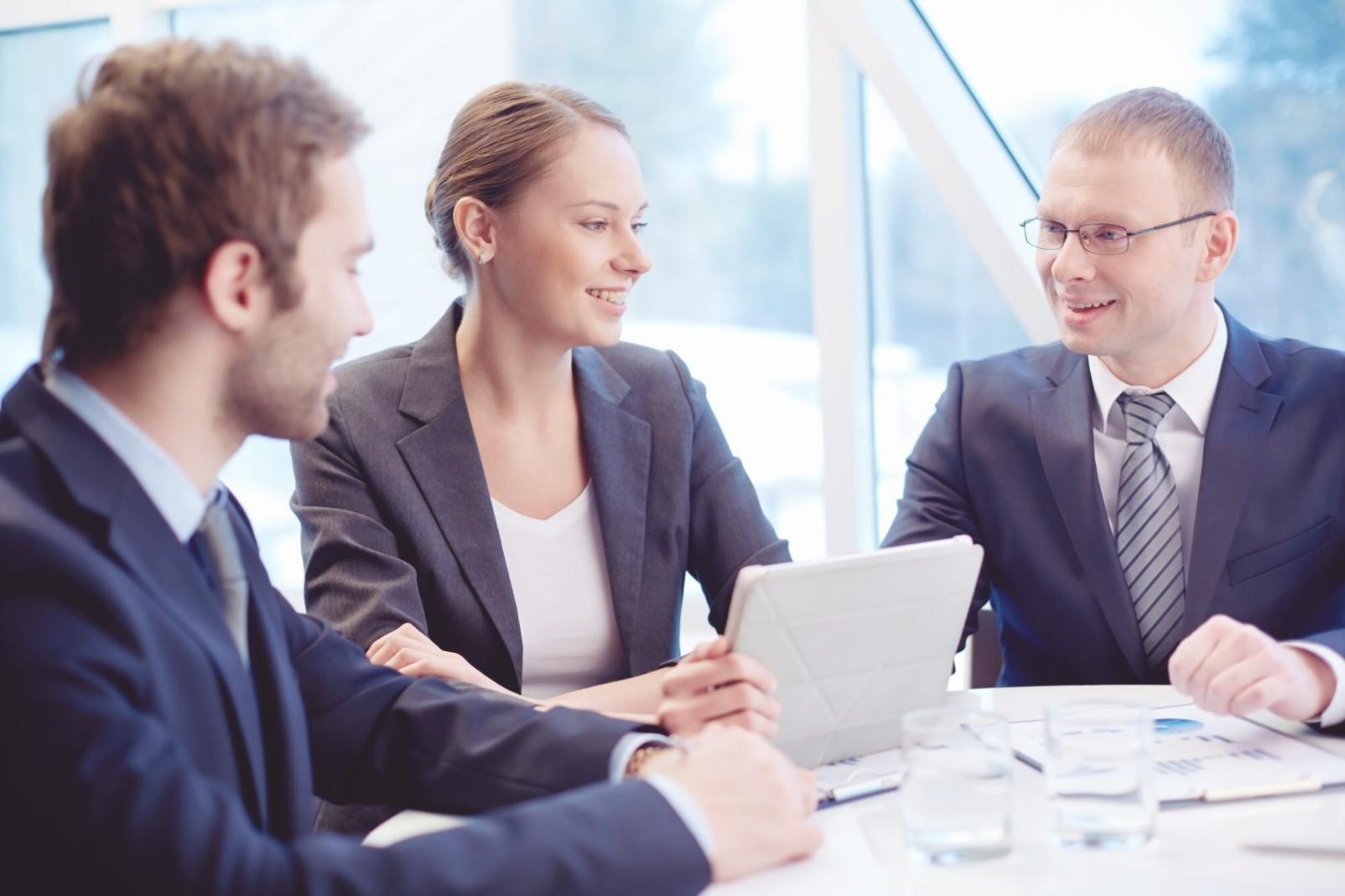 Financial professionals collaborating on investment analysis in a modern learning environment